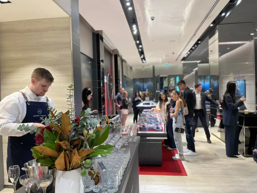 Bartender serving guests at a TAG Heuer boutique event