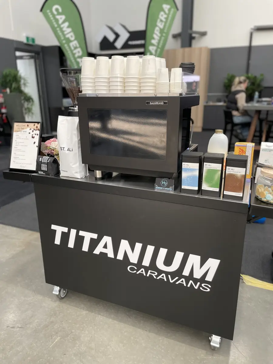 Coffee cart branded for Titanium Caravans at a showroom event