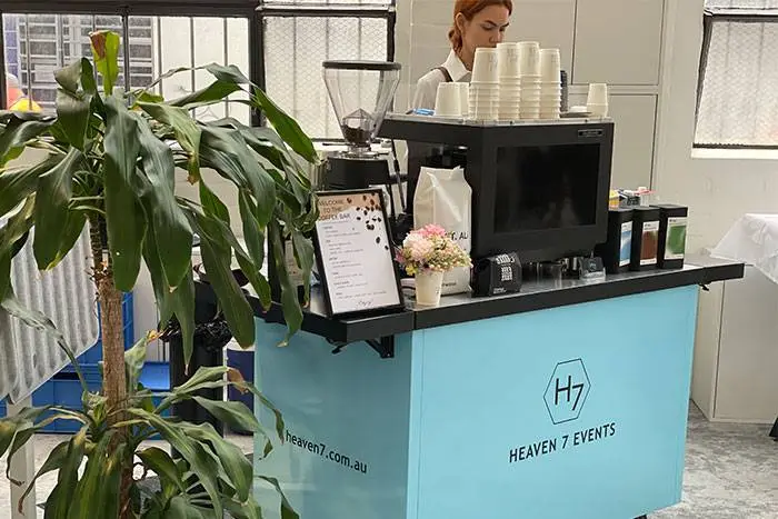 Heaven 7 Events coffee cart with a barista at a corporate office event