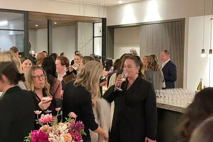 Guests mingling with drinks at a corporate event with a Heaven 7 Events bar