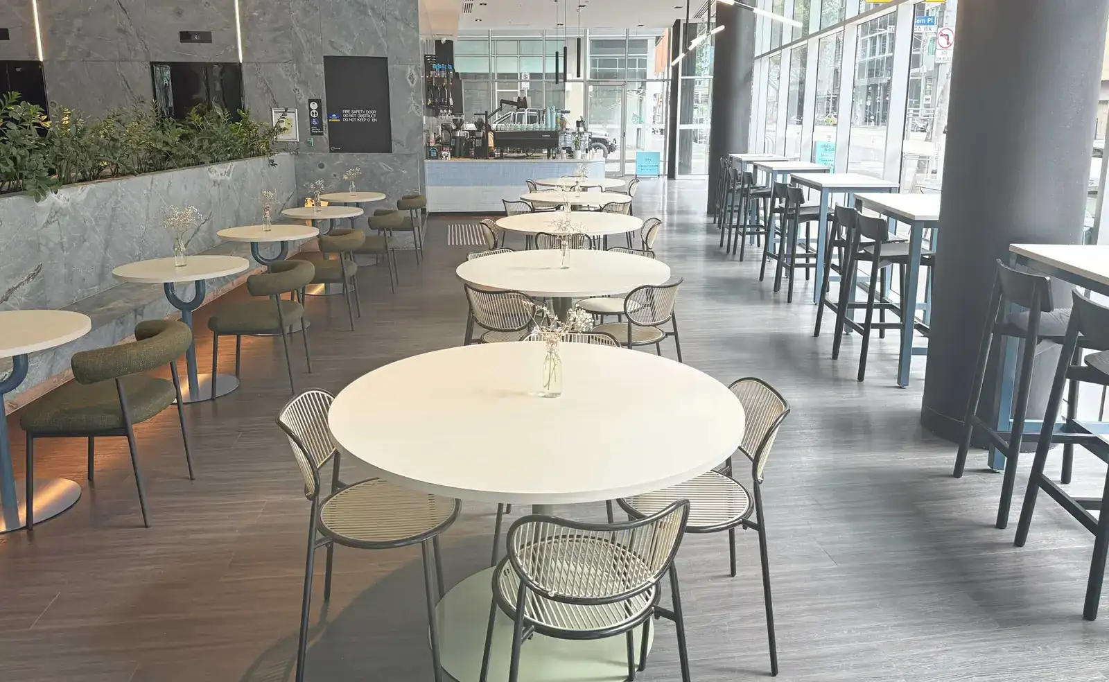 White tables and chairs set out in the Heaven 7 Cafe venue