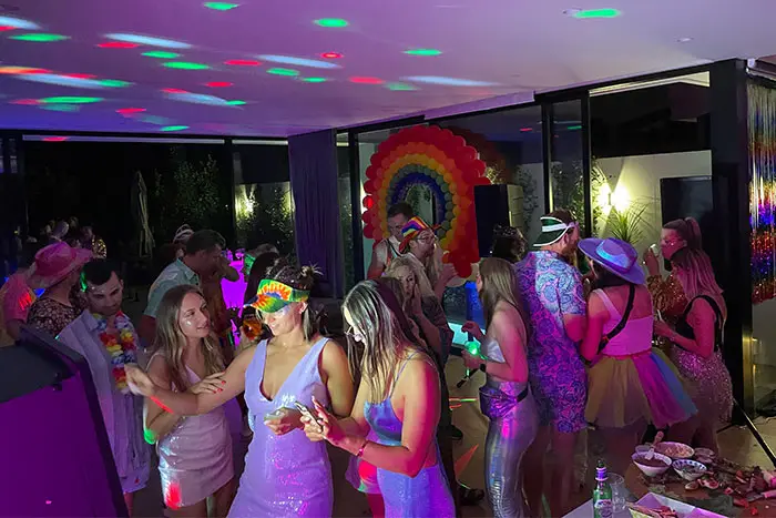 Friends dancing under disco lights at a birthday party