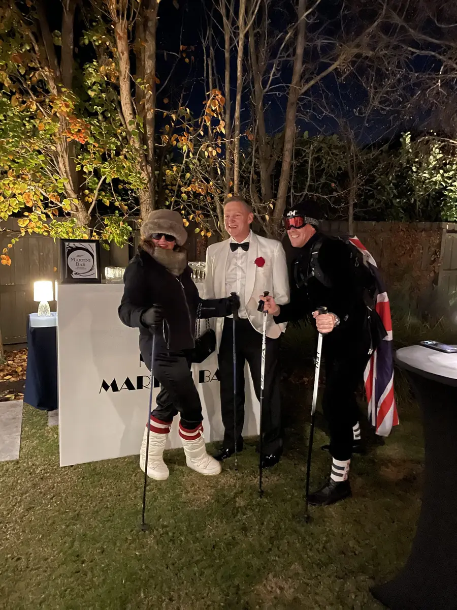 Guests in costume at a night-time garden party
