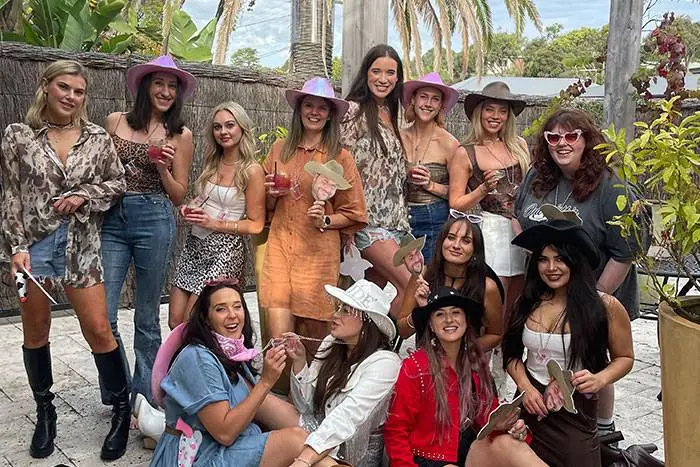 Hens party group in cowboy hats at a backyard celebration