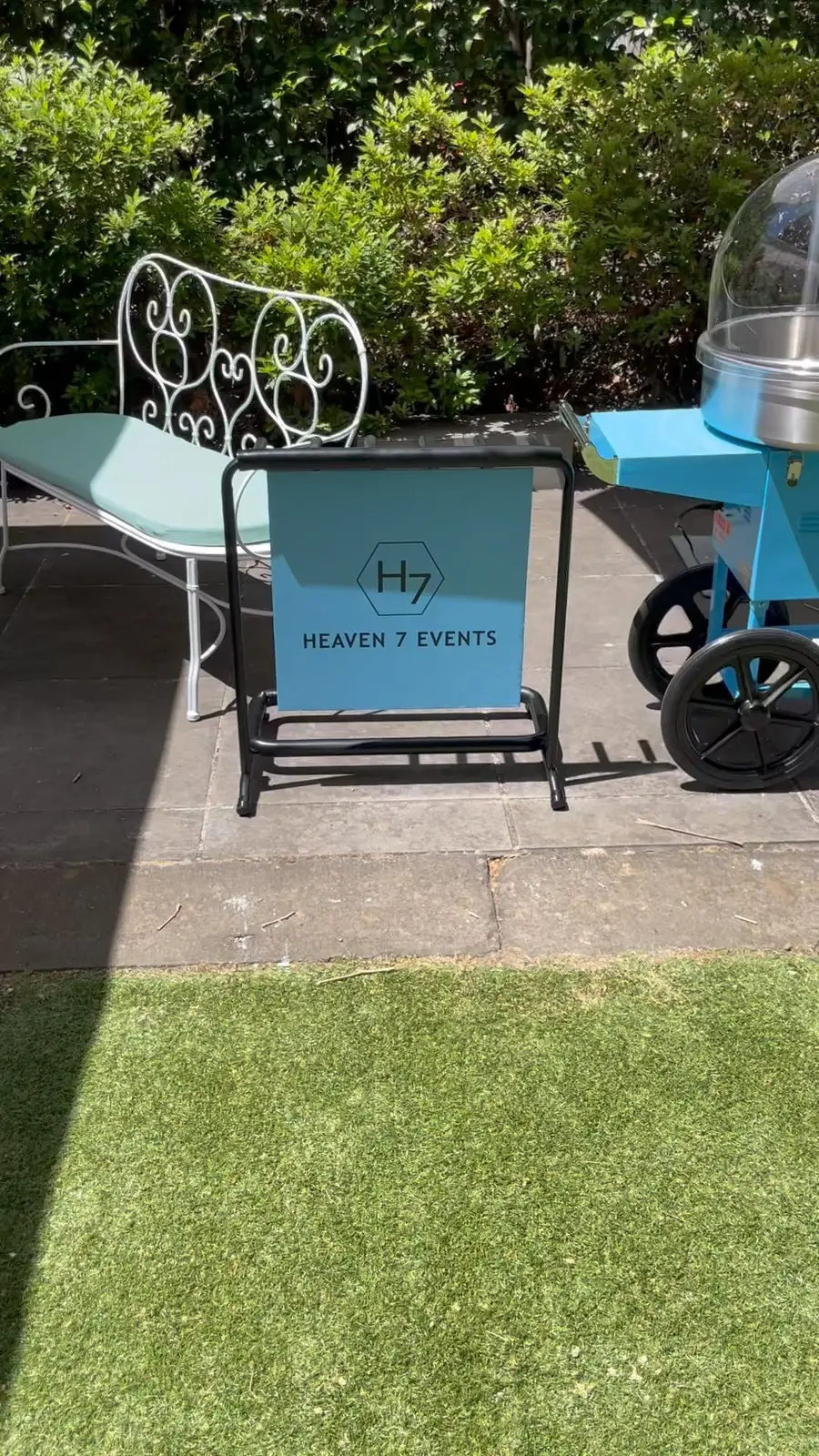 Heaven 7 Events sign beside a cart on the lawn at the Hellenic Museum