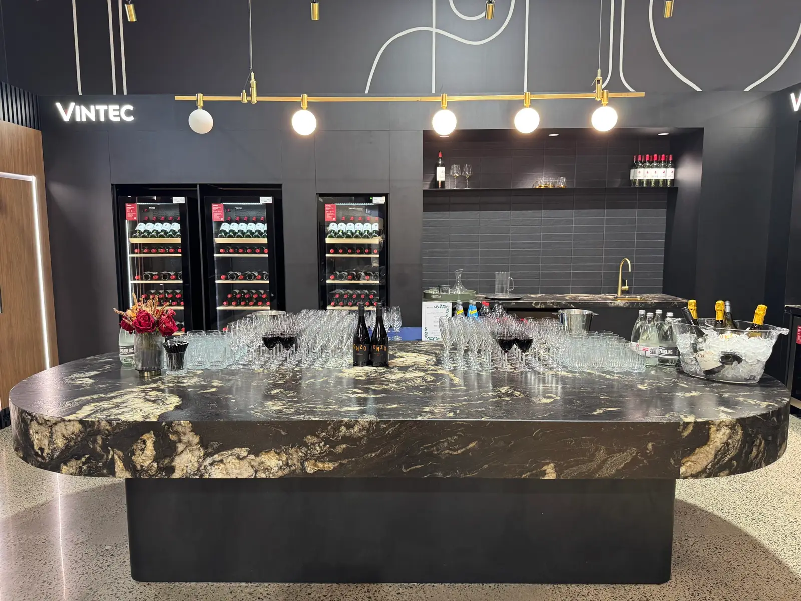 Glassware set out on a marble bar at a Vintec showroom event