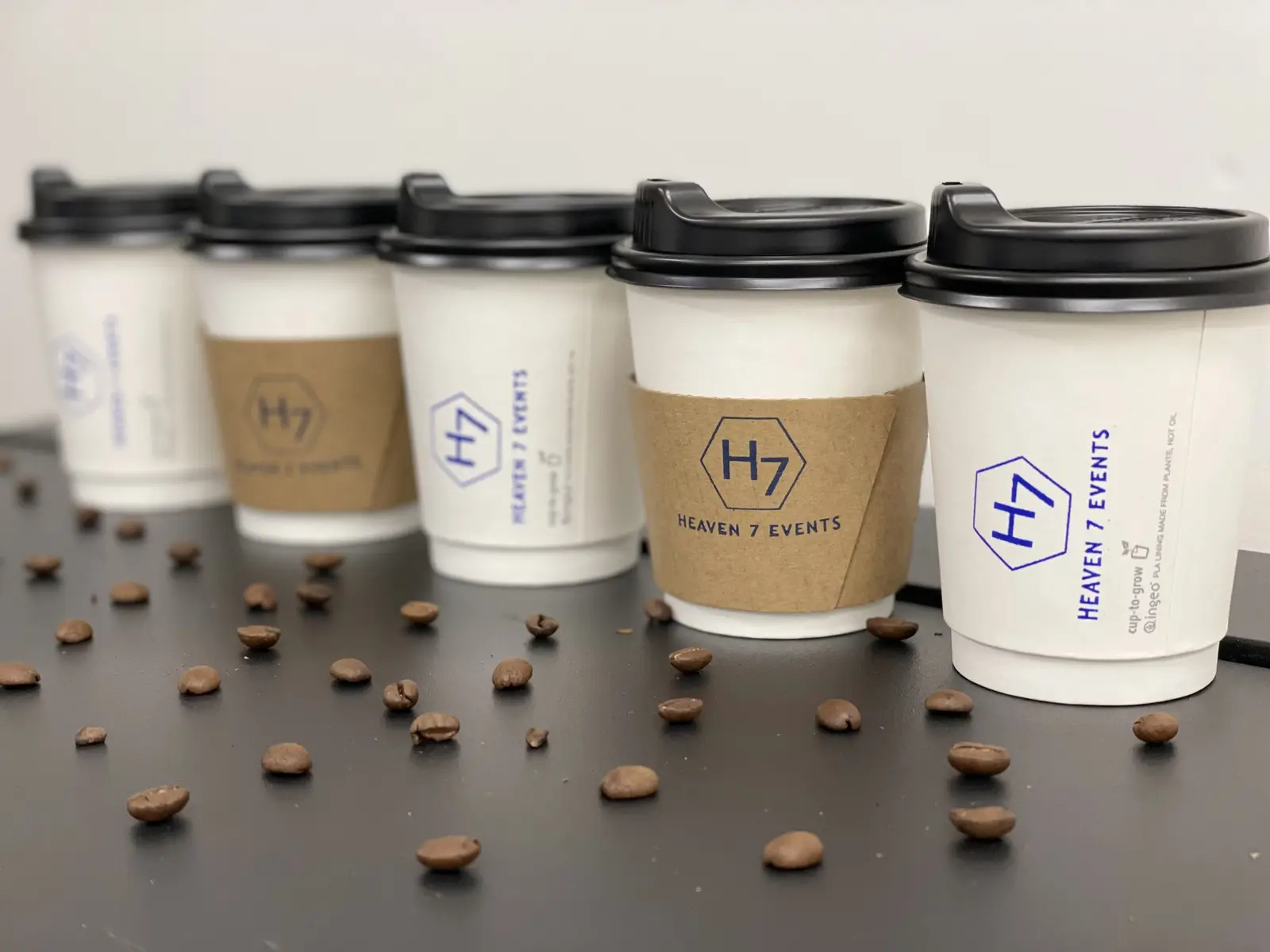 Heaven 7 Events branded coffee cups with coffee beans