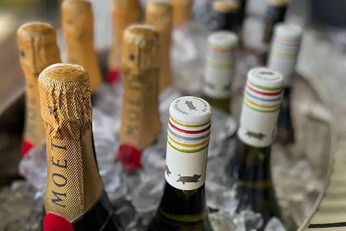 Moët and wine bottles chilling on ice at a private party bar