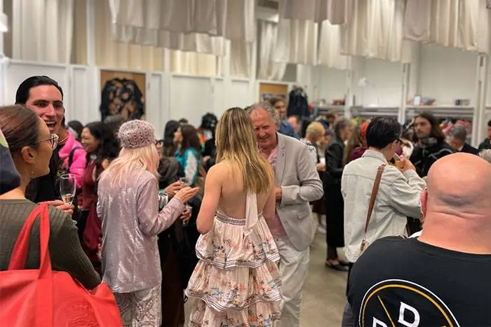 Guests mingling with drinks at a product launch event