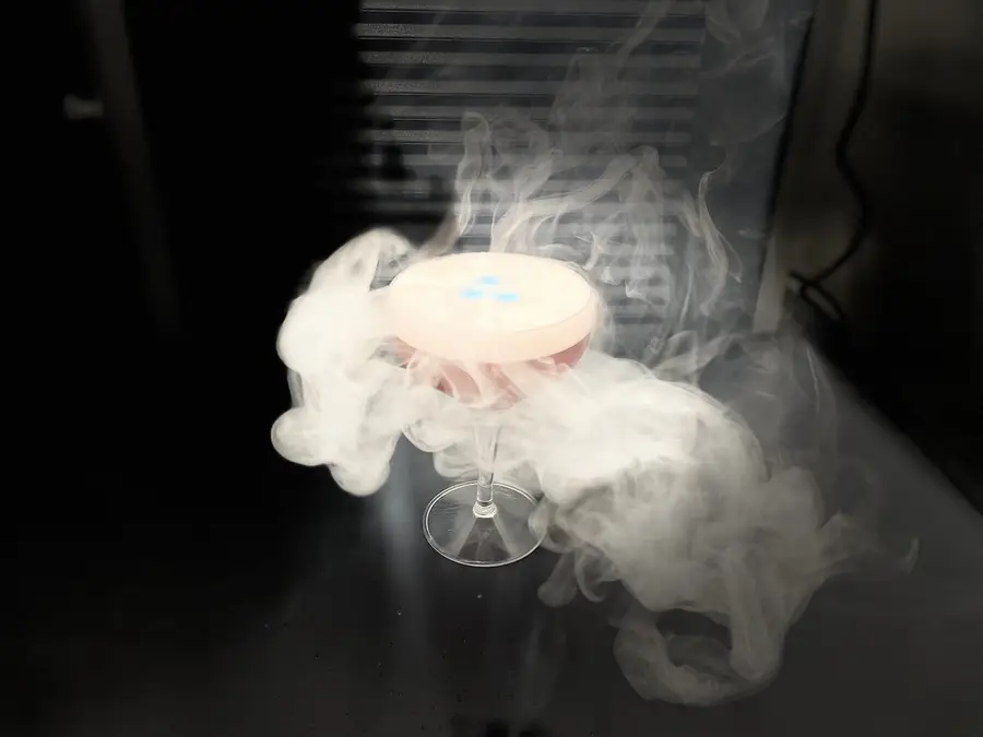 Smoking pink cocktail in a coupe glass