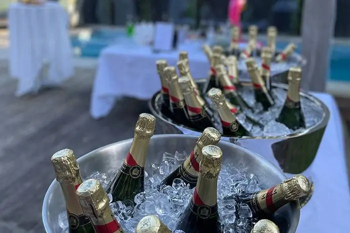 Champagne bottles on ice in silver buckets at a business launch