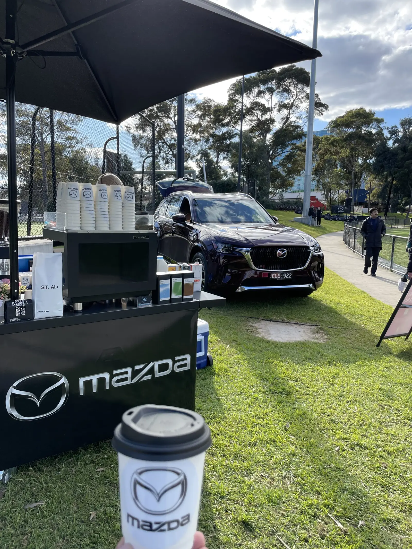 Mazda-branded coffee cart serving guests at an outdoor event