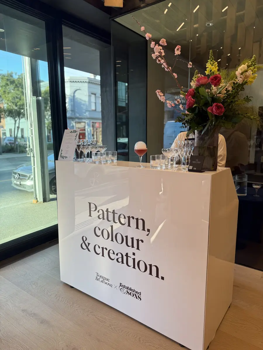 White mobile bar with flowers at a design showroom launch